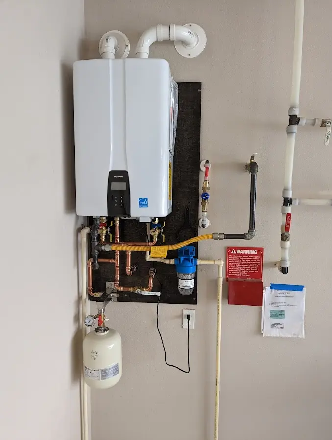 Professional plumber installing copper piping in a Lake Alfred home